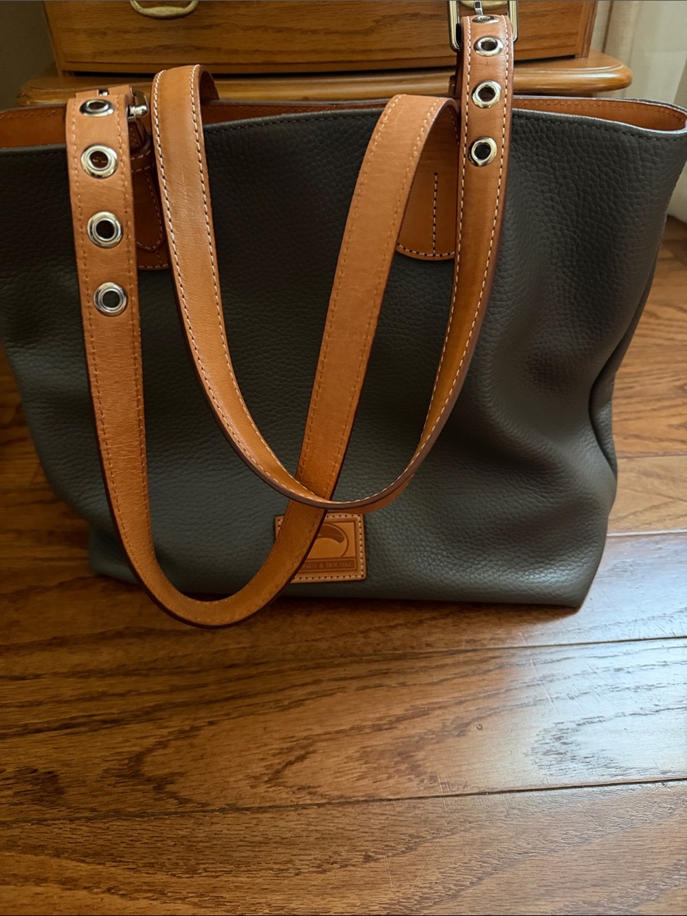 Dooney & Bourke Tote with Tan Leather Straps and Grommet Details